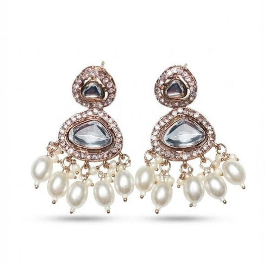 Pair of Noor Polki drop earrings featuring clear Kundan-style stones with white crystal borders and dangling freshwater pearl drops on a white background