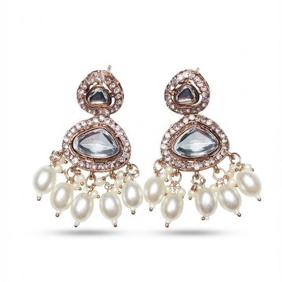 Pair of Noor Polki drop earrings featuring clear Kundan-style stones with white crystal borders and dangling freshwater pearl drops on a white background