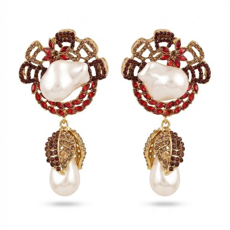 Ruby red accented gold drop earrings featuring white baroque pearls and red stones