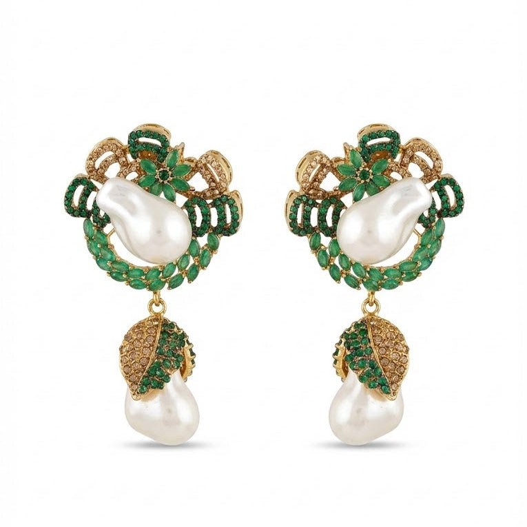 Emerald green accented gold drop earrings featuring white baroque pearls and green stones