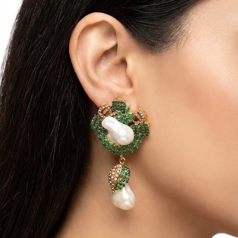 Close-up of model wearing emerald green and pearl drop earring