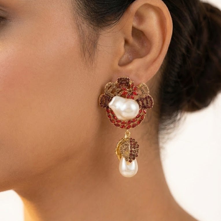 Model wearing ruby red stone and pearl drop earring with hair pulled back