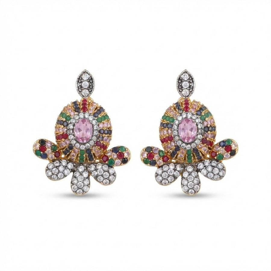 Ruby red floral gemstone studs displayed on beige background with yellow flowers nearby