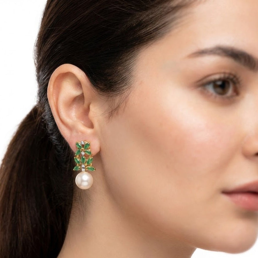 Bright daylight image focusing on black marquise stones pearl drop earrings held in hand