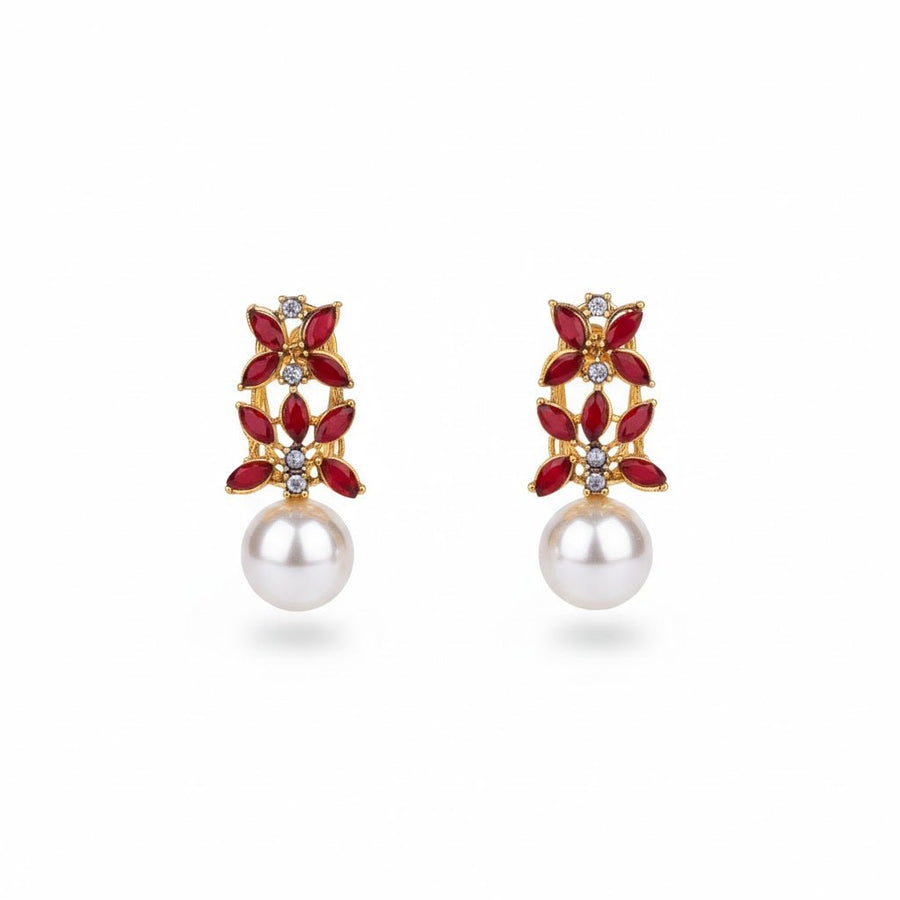 Gold-tone red stone and pearl drop earrings on white background