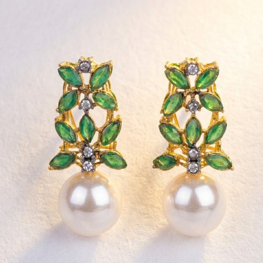 Individual holds large multicolor stone pearl drop earrings against natural daylight background