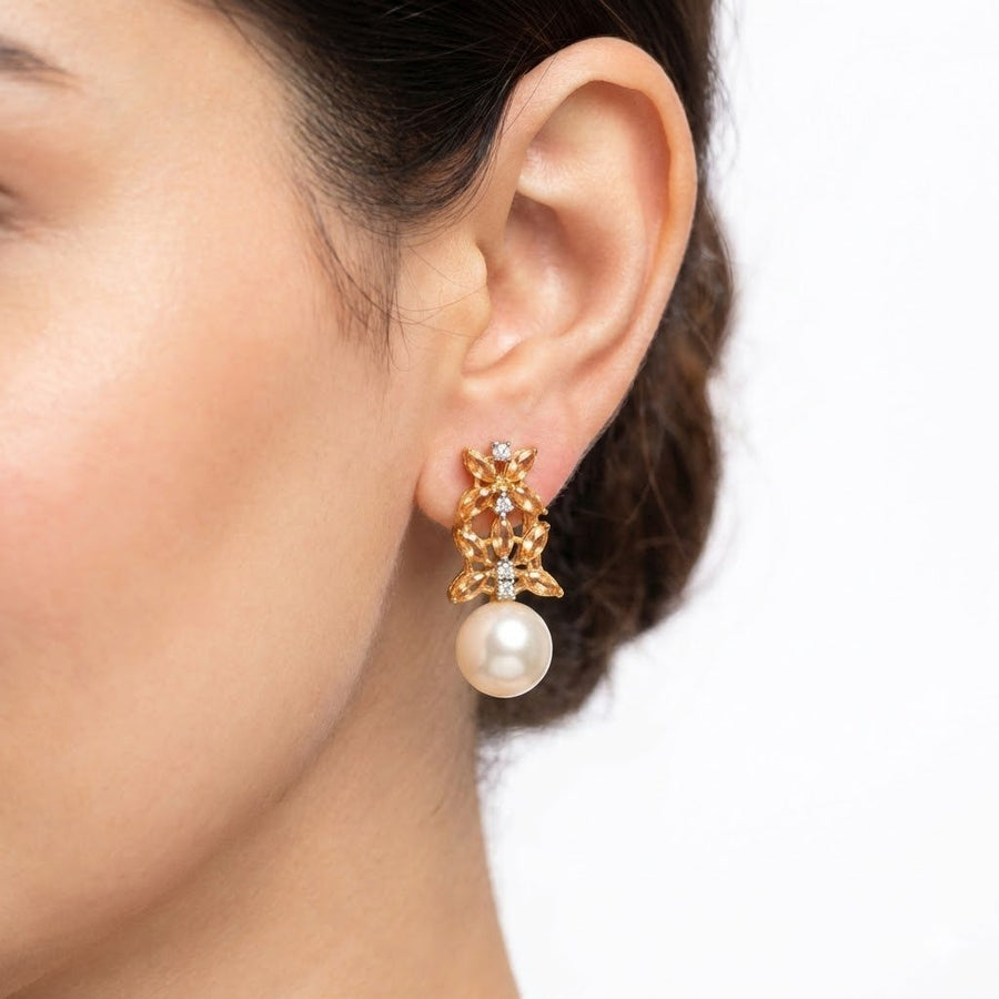 Pair of multicolor stone pearl drop earrings with various gem hues on white background