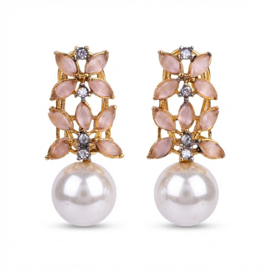 Black stone accented pearl drop earrings on white background