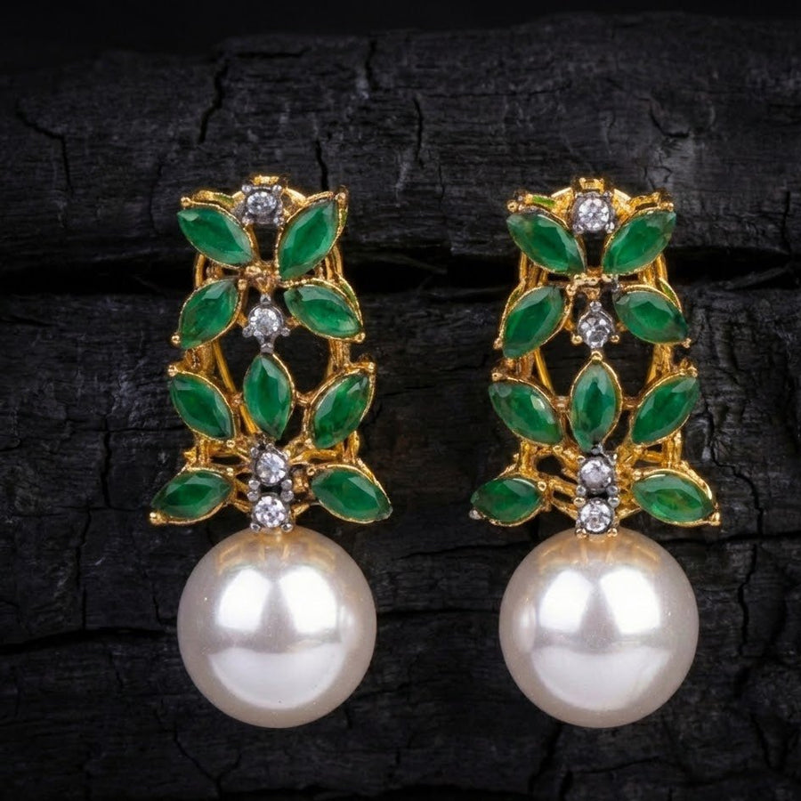 Detailed photo of gold-tone earrings with red gemstones and white pearl drops