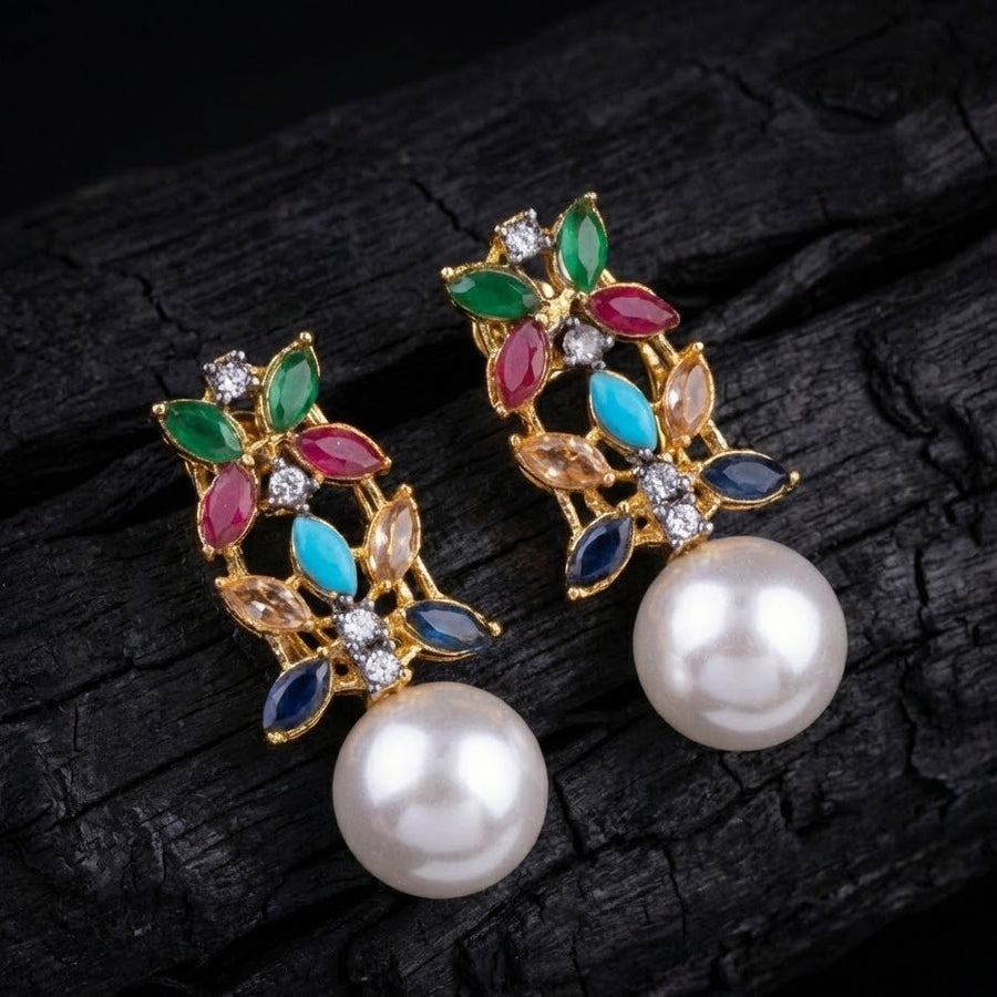 Multicolor pearl drop earrings displayed on black textured background highlighting colors and pearl shine