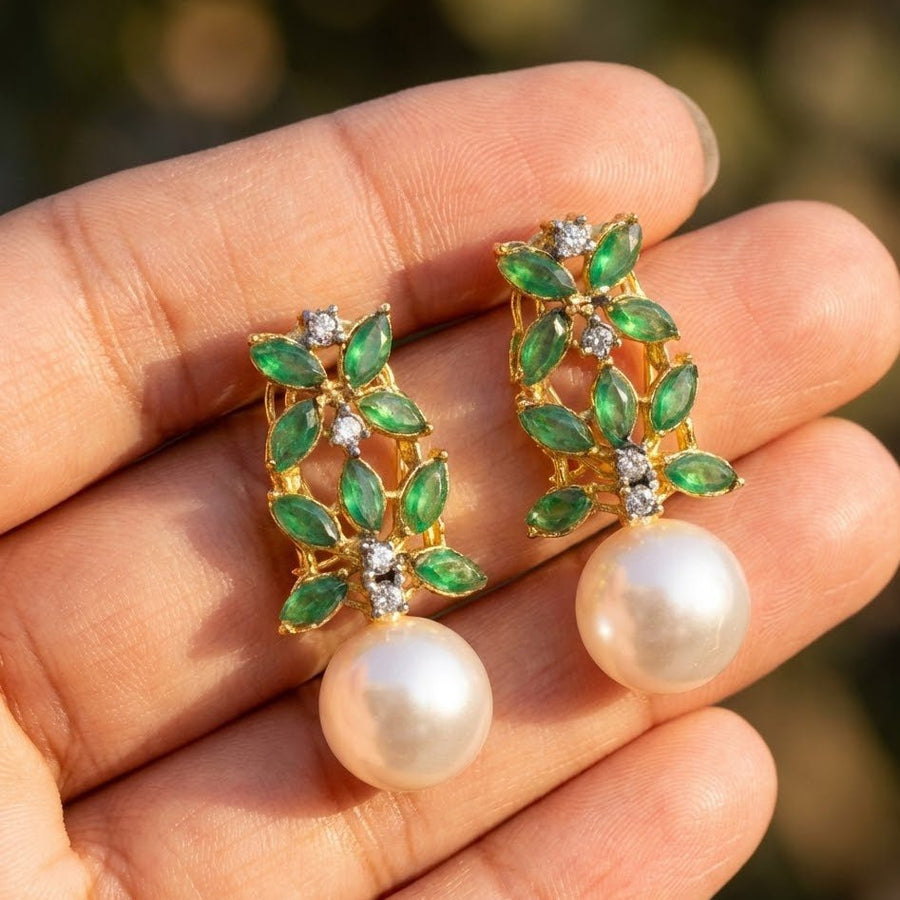 Immaculate showcase of multicolor marquise stones and large pearl drop earrings on white