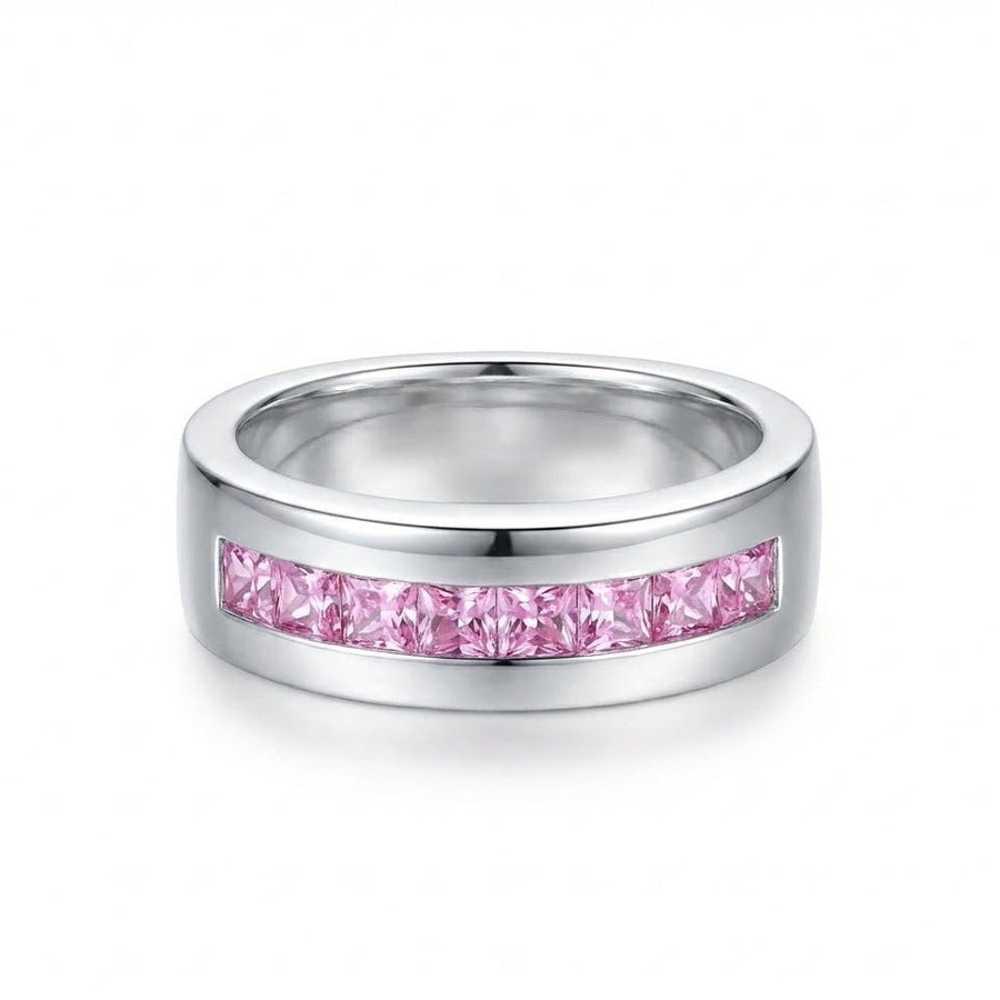 Close-up of polished silver band ring featuring a row of nine square-cut pink stones set in a channel