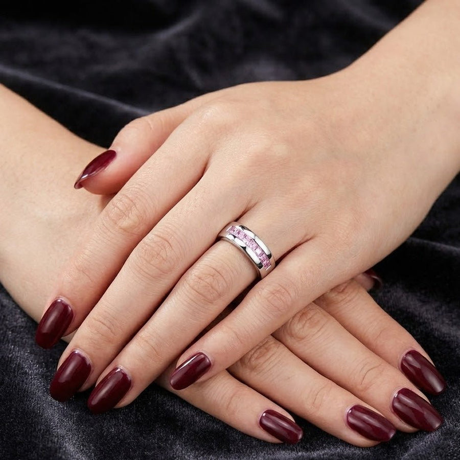 Ring worn on hand with dark red manicured nails, showcasing its elegant look on a finger