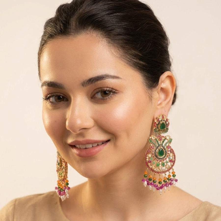 Woman wearing colorful multi-gemstone jhumka earrings showcasing their length, vibrant colors, and elegant design