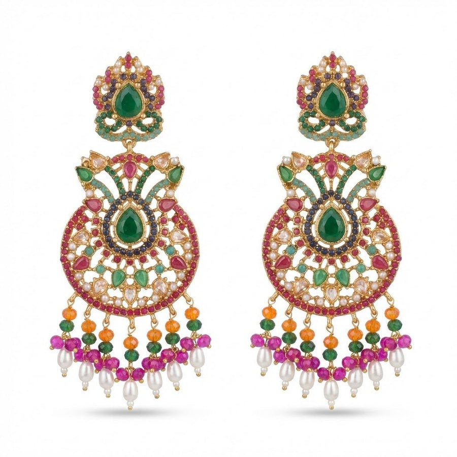 Close-up of colorful multi-gemstone jhumka earrings with green central stone, pink and orange bead accents, and pearl dangles on white background