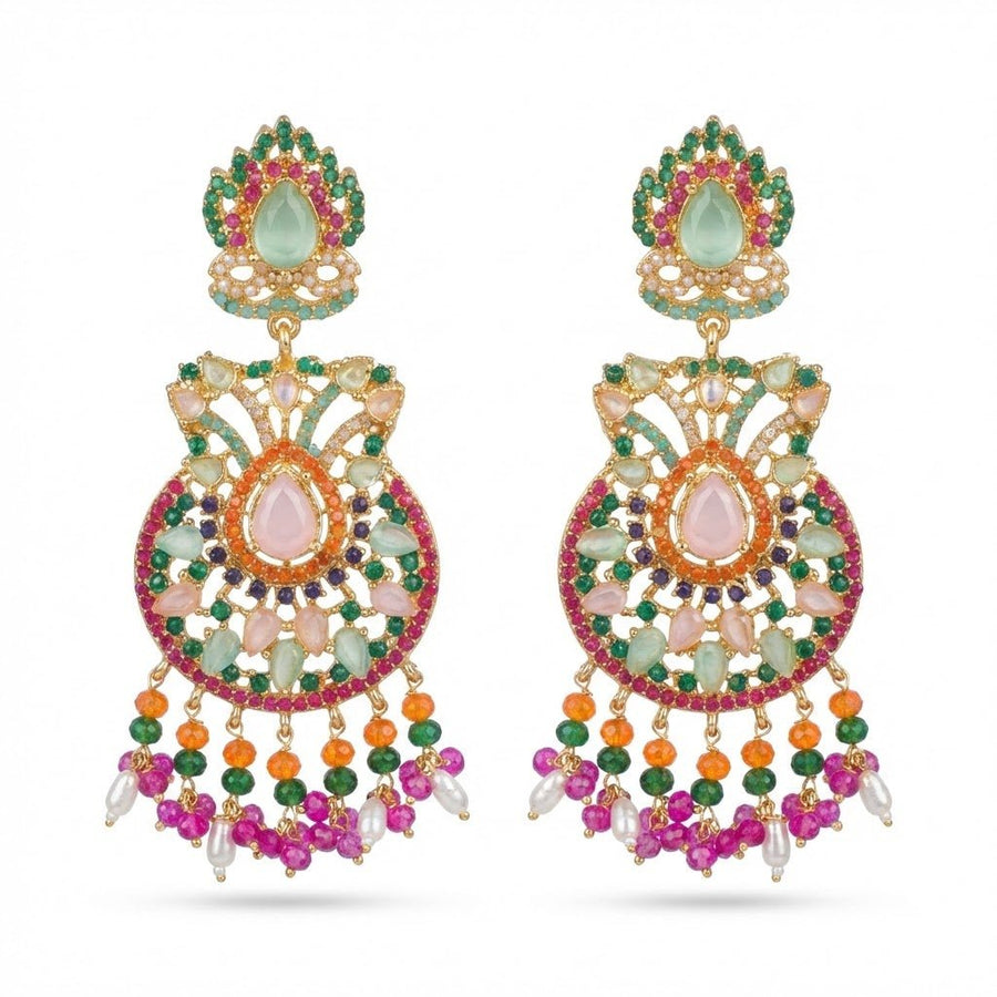 Close-up of pink, green, orange, and white gemstone jhumka earrings on black charred wood background with small dangling pearls
