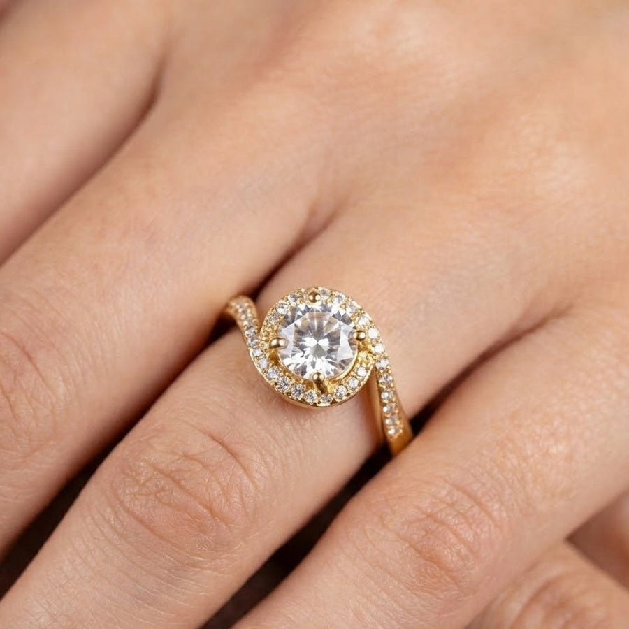 Gold halo diamond ring worn on woman's finger showing fit and elegant sparkle