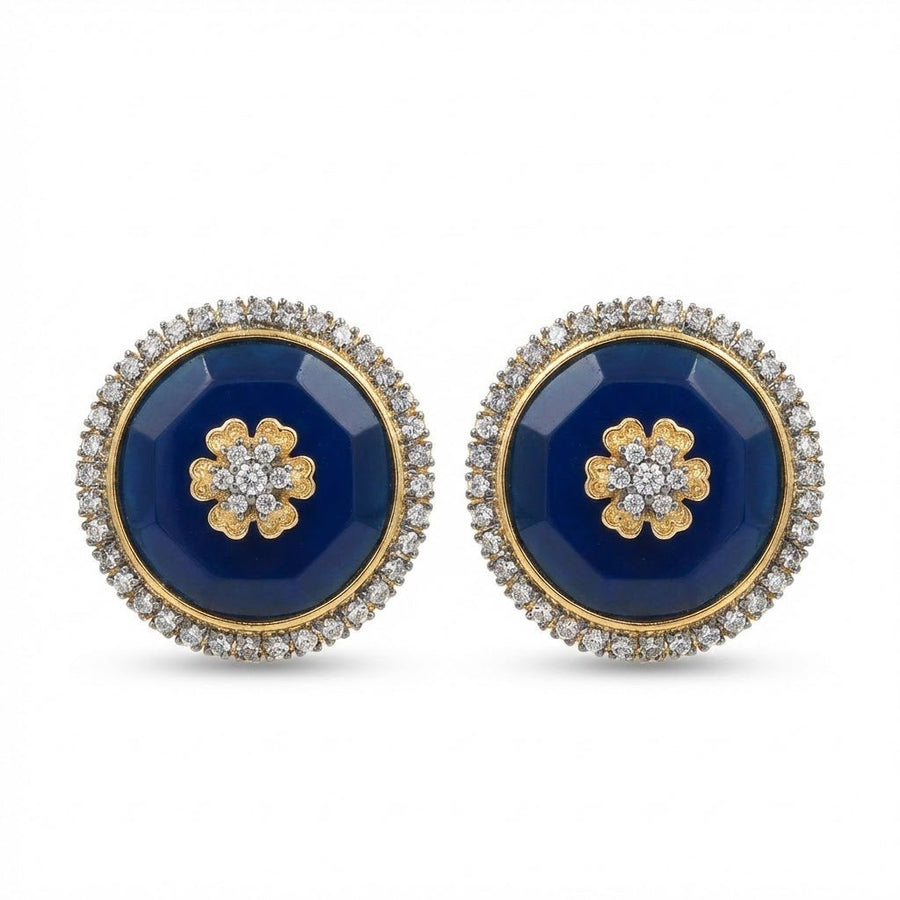 Navy blue faceted stone round stud earrings with flower motif and halo of sparkling stones displayed on white background