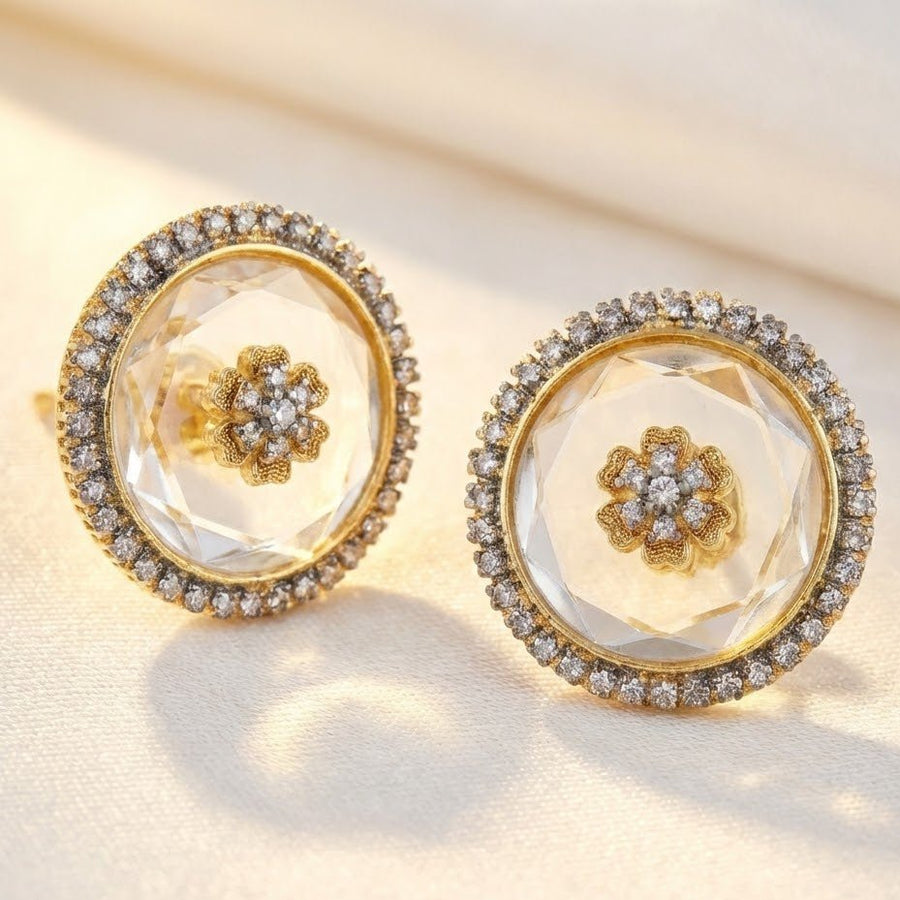 Model presenting emerald green faceted stone round stud earrings with sparkling halos, dressed in coordinated green embroidered outfit