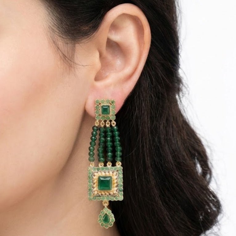 Pair of long blue gemstone bead earrings with gold-tone square motifs and teardrop pendants