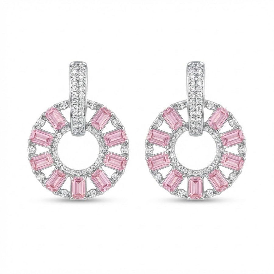 Silver plated circle drop earrings with clear baguette stones held on hand in natural light