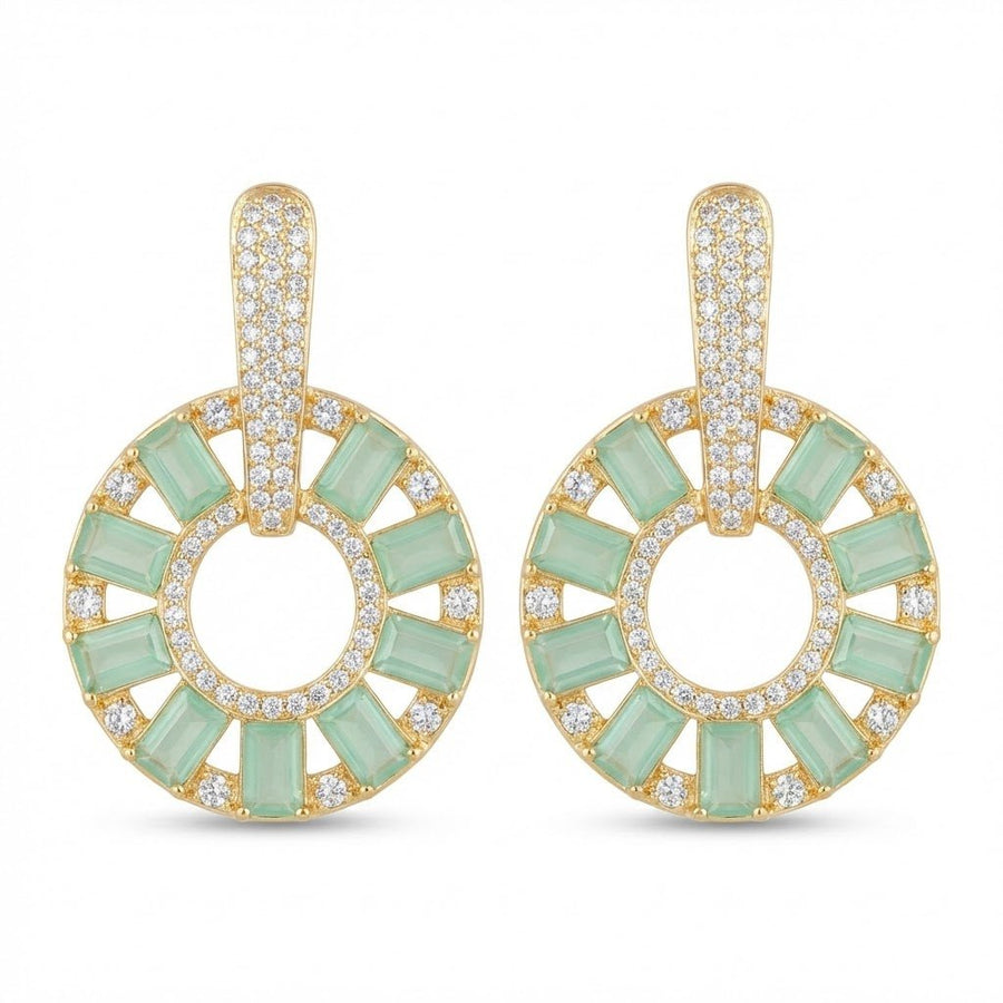 Gold plated light green stone circle drop earrings resting on beige cloth